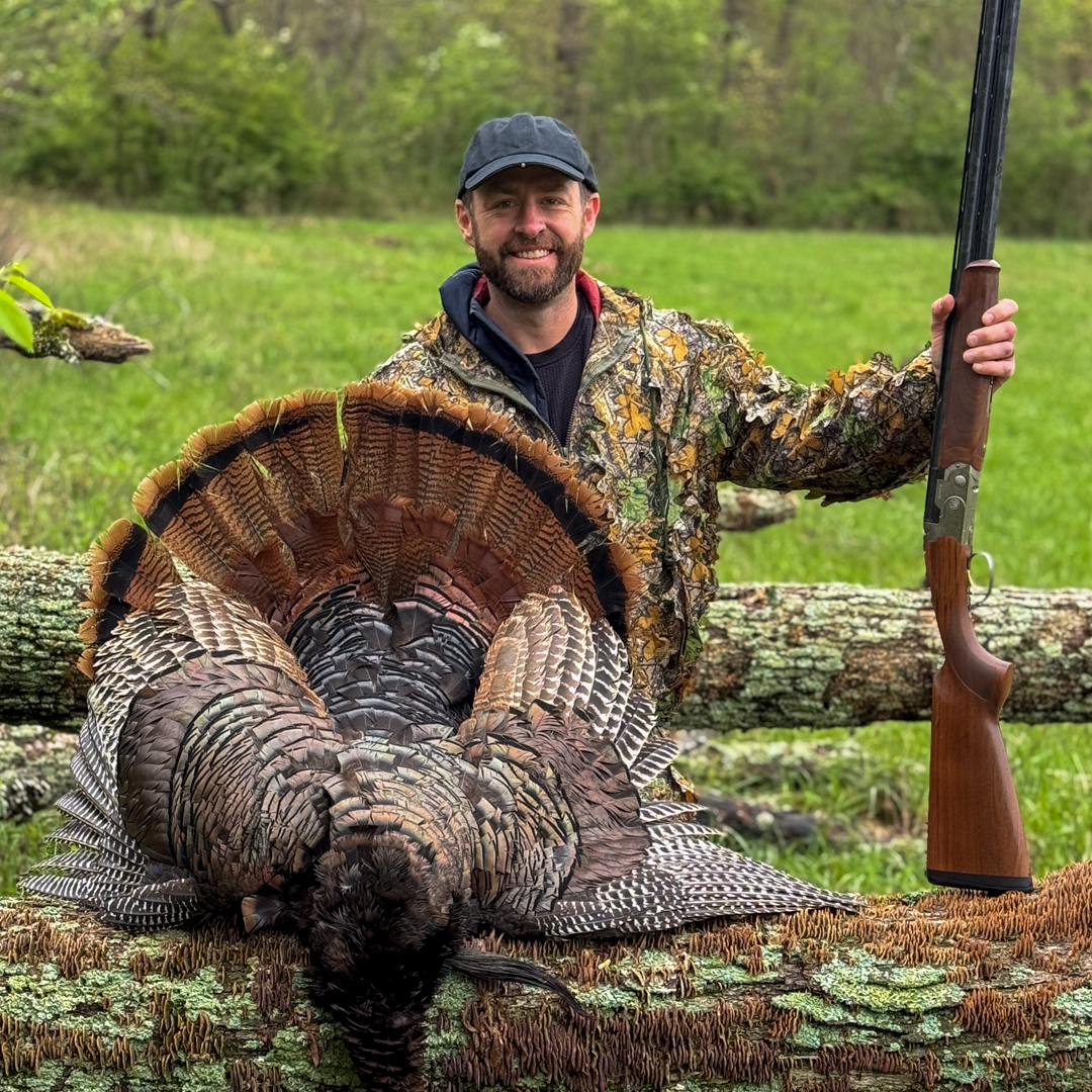 Chip Lee holiding a shotgun after shooting a tom/turkey
